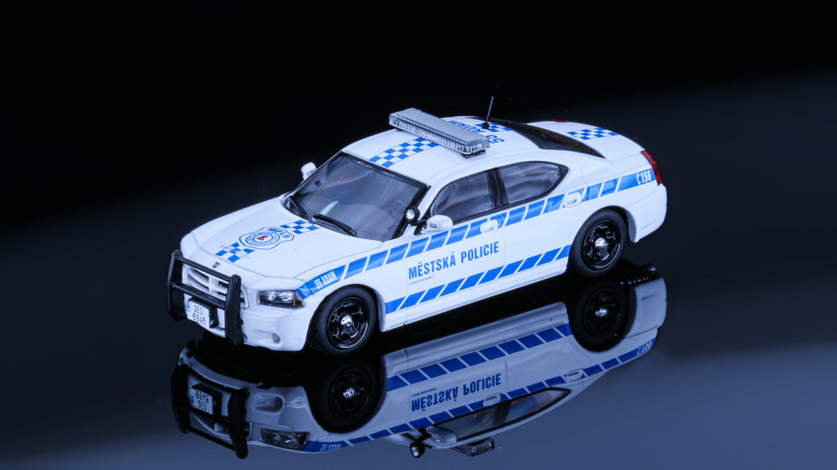 JR Collectibles x Rollin – Městská Policie Lázně Bohdaneč “Adam” 1:64 scale police car with blue-and-white livery.