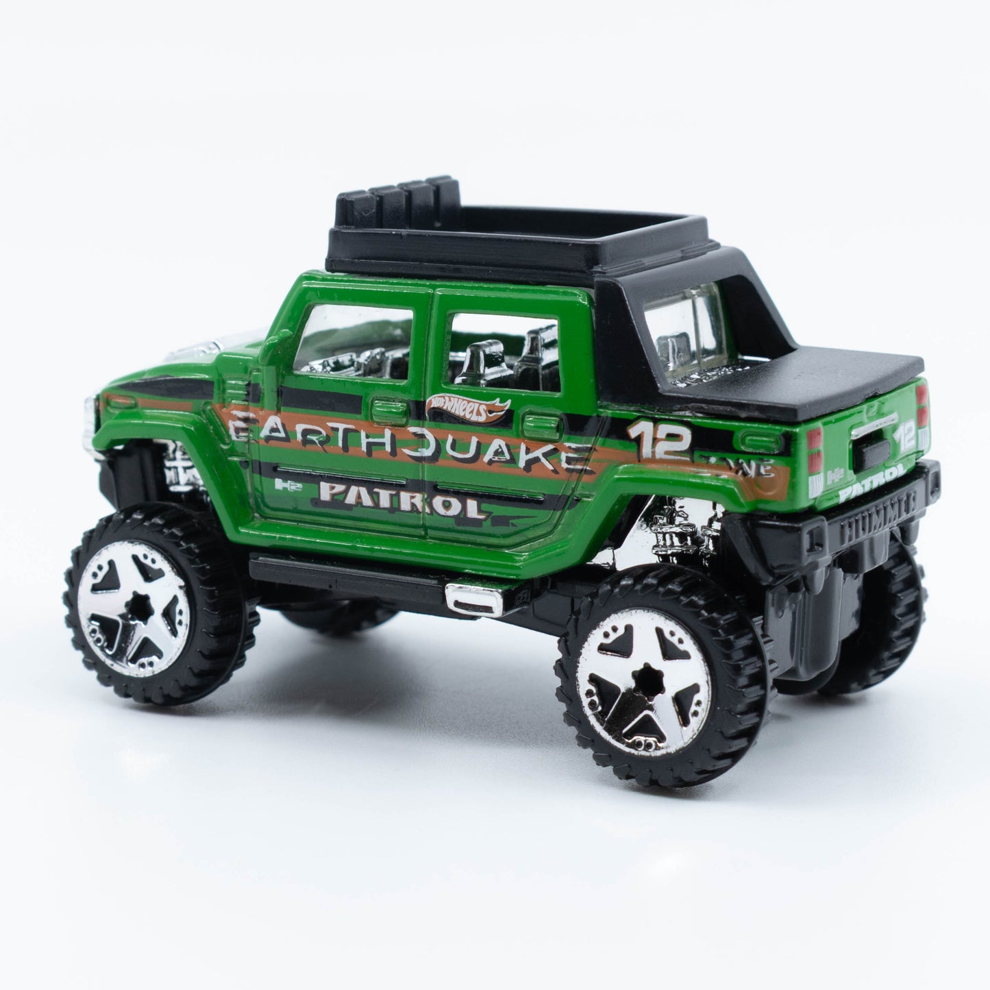 Hot Wheels Hummer H2 SUT diecast model in 1:64 scale with lifted suspension and off-road styling. Back
