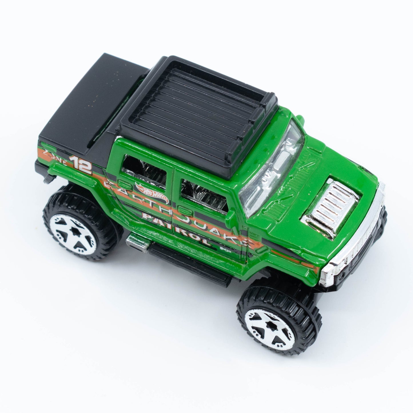 Hot Wheels Hummer H2 SUT diecast model in 1:64 scale with lifted suspension and off-road styling. Top