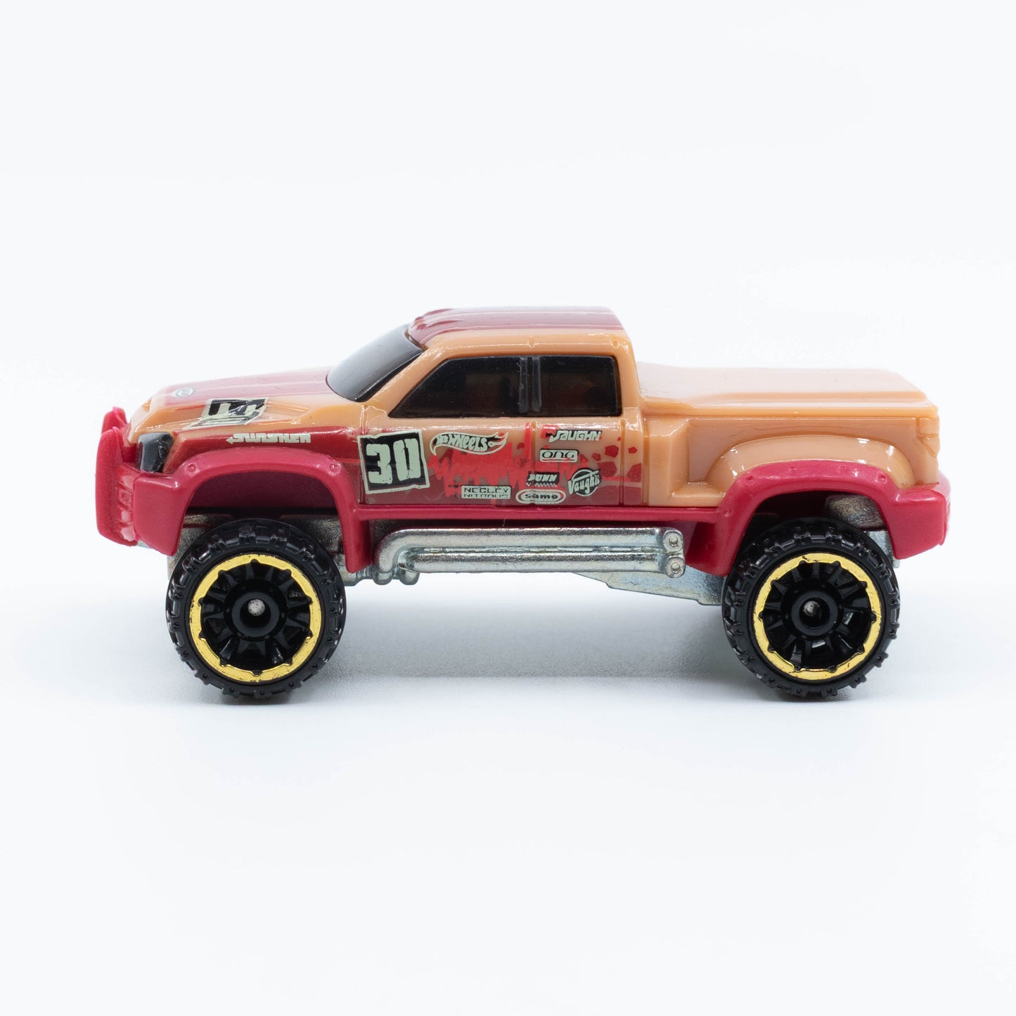Hot Wheels Mega-Duty 1:64 diecast truck with lifted suspension and rugged utility styling. Side