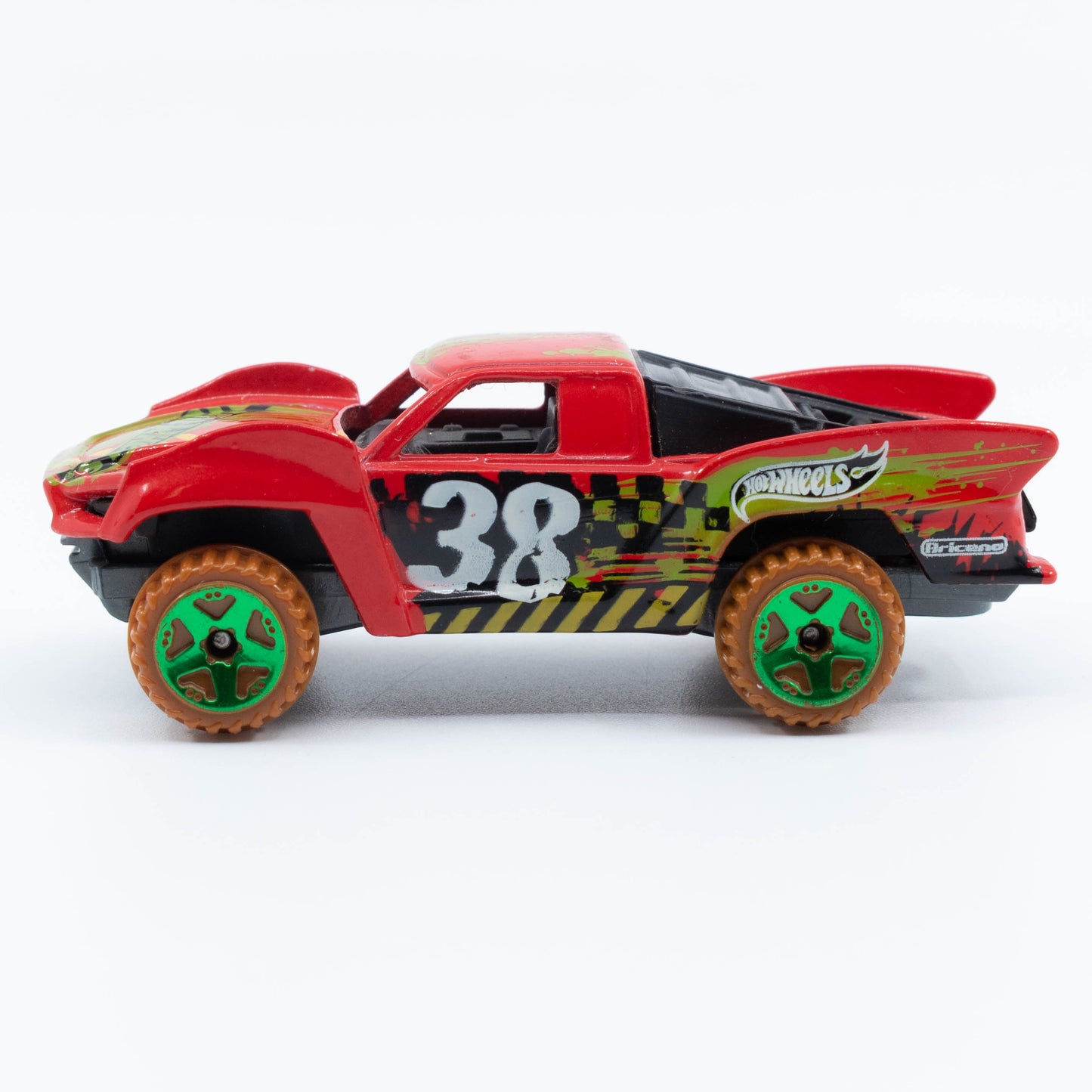 Hot Wheels Baja Truck in 1:64 scale with lifted suspension, roof rack, and off-road racing graphics. Side
