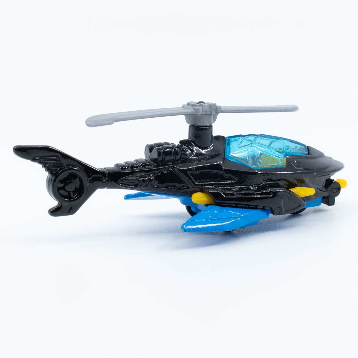 Hot Wheels Batcopter in 1:64 scale with black bat-wing design and spinning rotor blades. Back