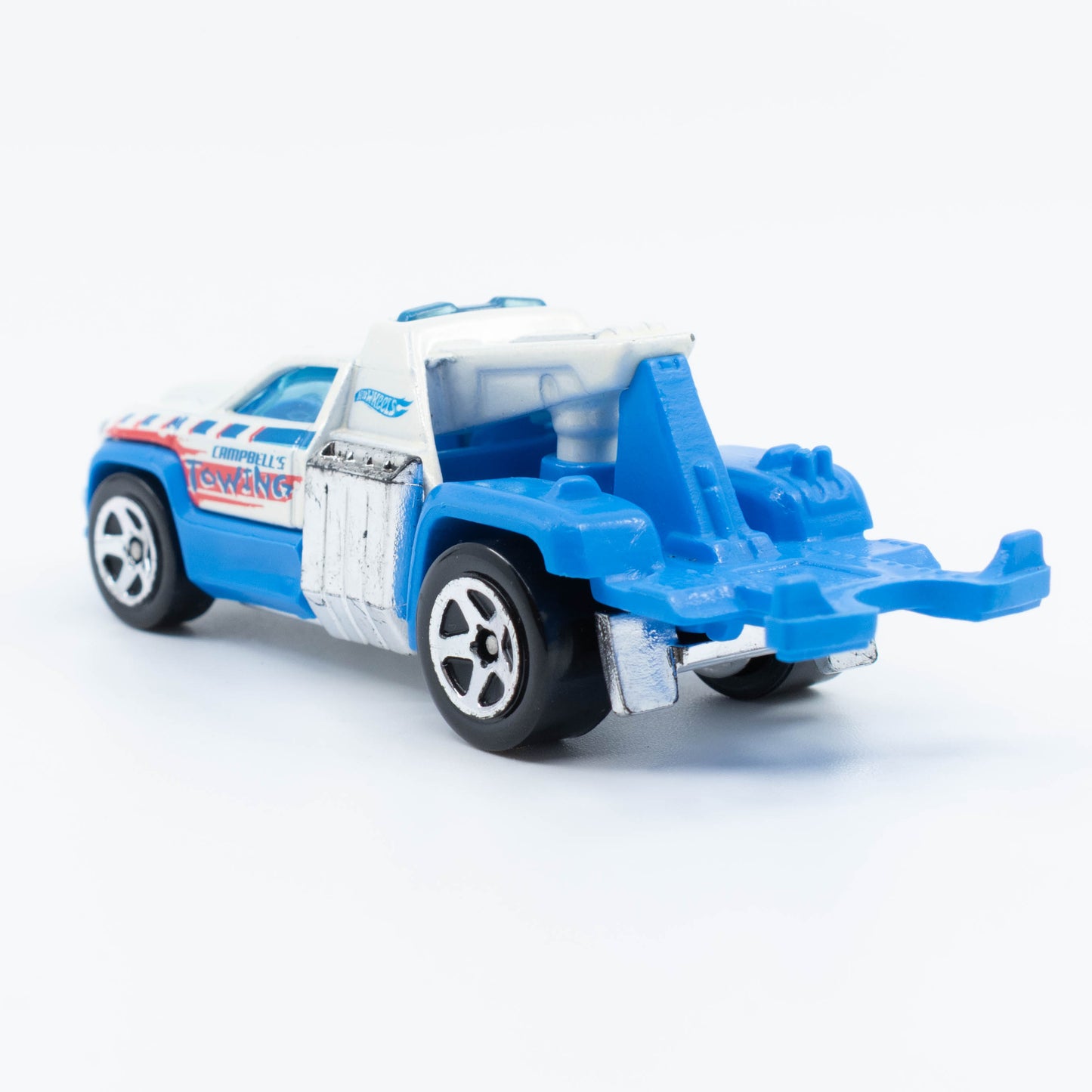 Hot Wheels Repo Duty tow truck with hook and utility bed in 1:64 scale. Back