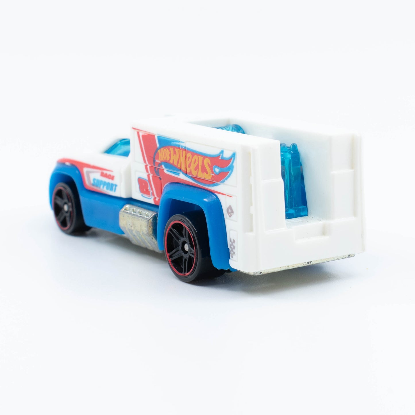 Hot Wheels Rescue Duty 1:64 scale emergency truck with light bar and white-and-blue rescue graphics. Back