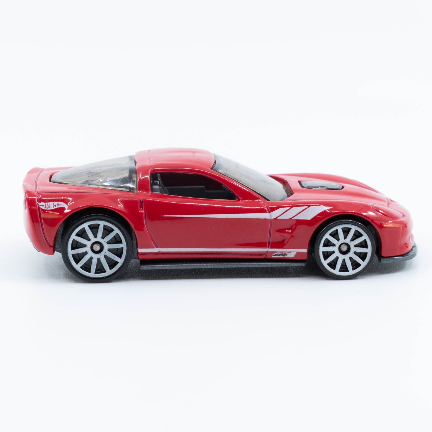 Hot Wheels diecast of the 2009 Corvette ZR1 with detailed body and clear hood showcasing engine. Side