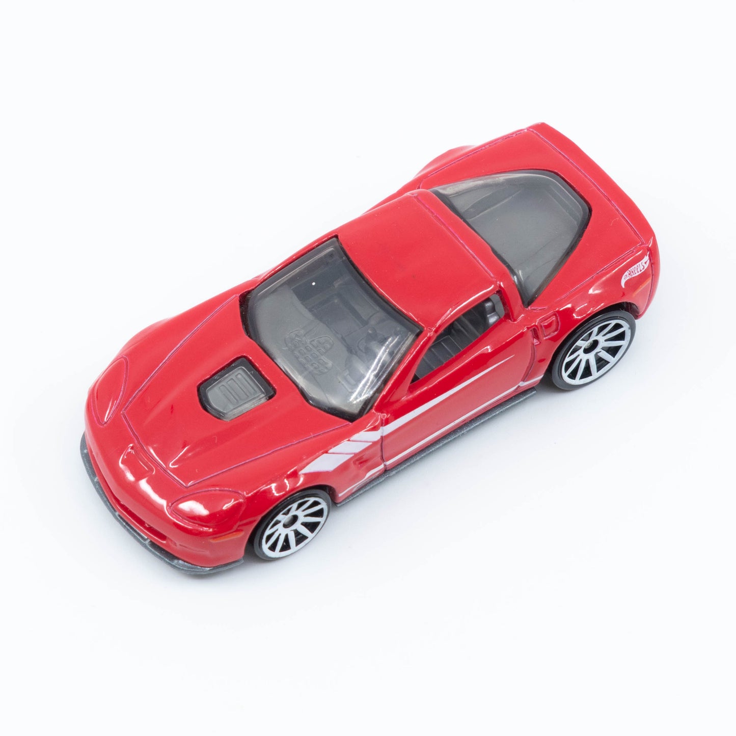 Hot Wheels diecast of the 2009 Corvette ZR1 with detailed body and clear hood showcasing engine. Top