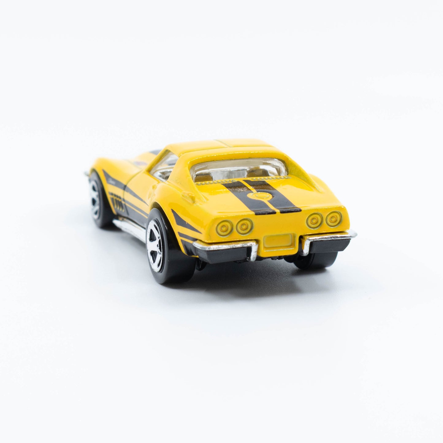 Hot Wheels 1:64 scale '69 Corvette diecast with classic muscle car design and detailed finish. Back
