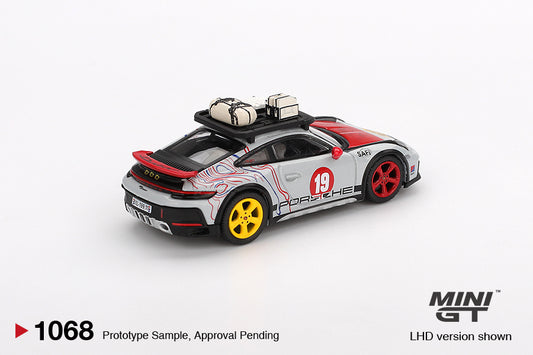 Mini GT Porsche 911 (992) Dakar Uncle Rally 2024 in 1:64 scale, featuring off-road livery and lifted suspension. Back