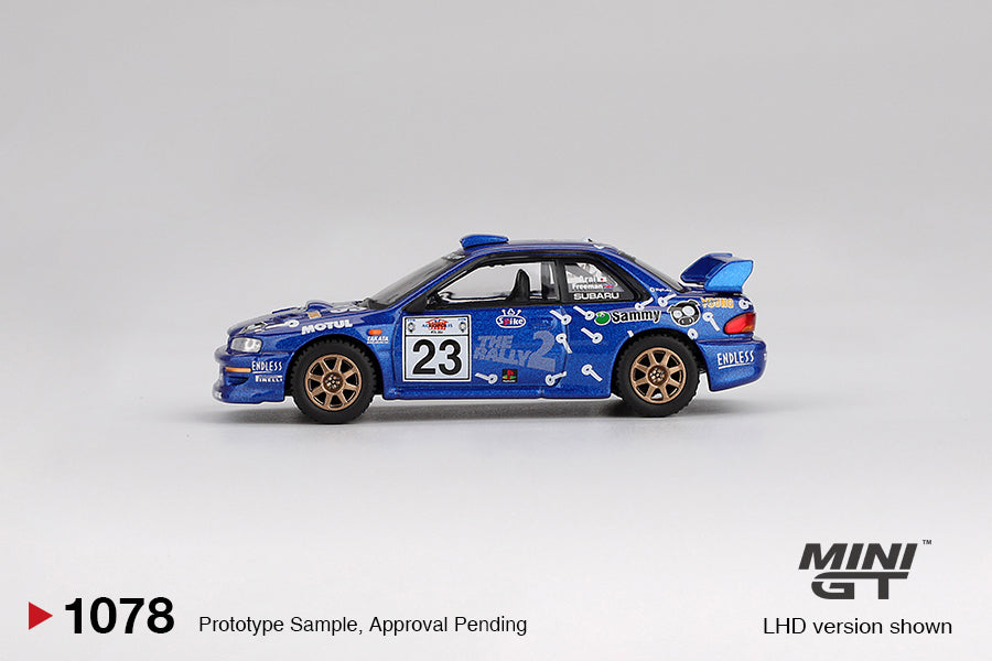 Mini GT Subaru Impreza WRC99 #23 from Acropolis Rally 2000 in blue rally livery with white graphics. Side