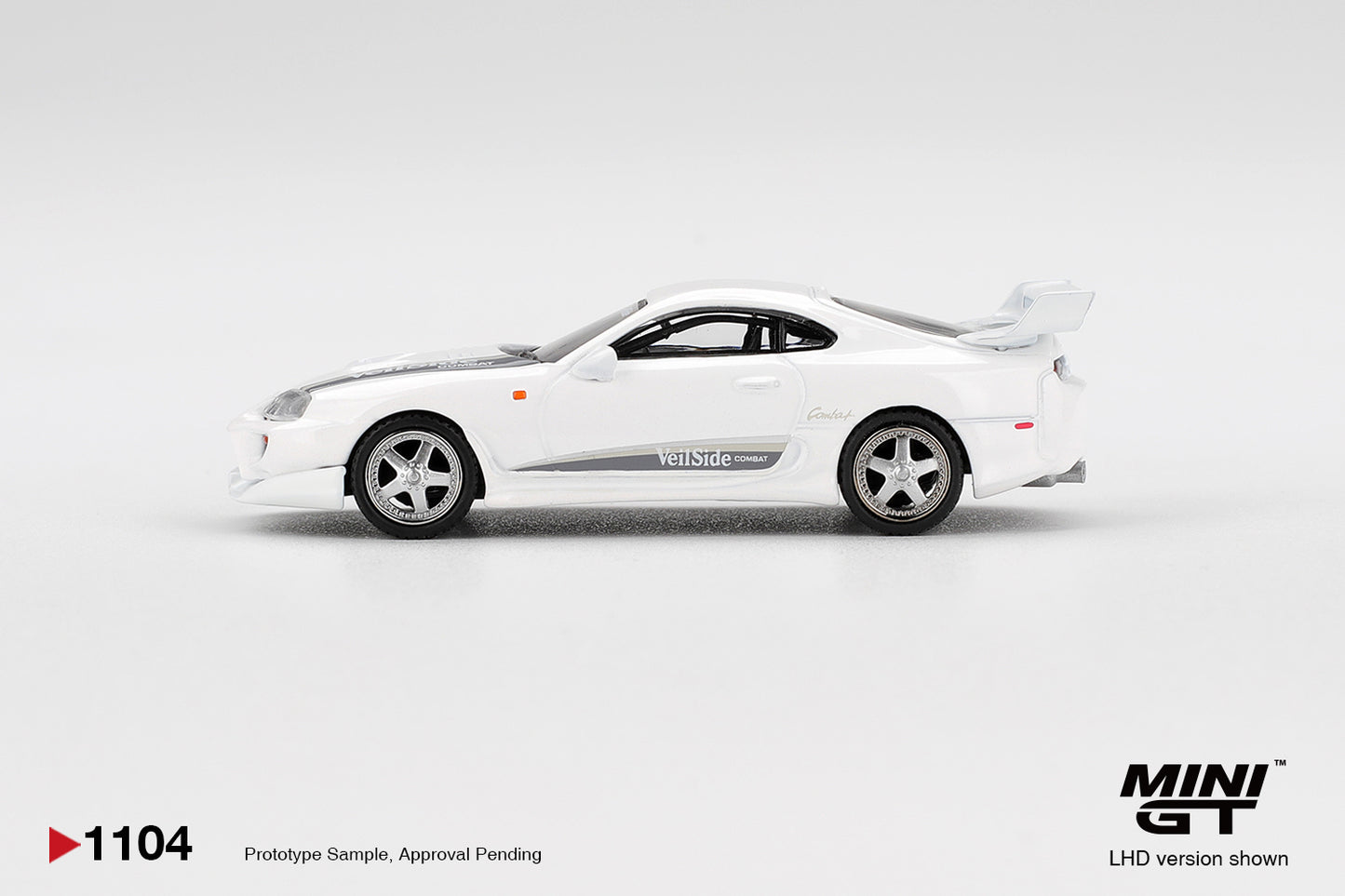 Mini GT 1:64 Toyota Supra MK4 A80 VeilSide Combat V-I white pearl metallic. Side