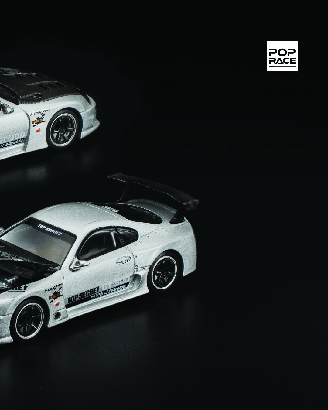 1:64 POP Race diecast model of Top Secret GT300 Toyota Supra in silver with widebody kit and rear wing. Right