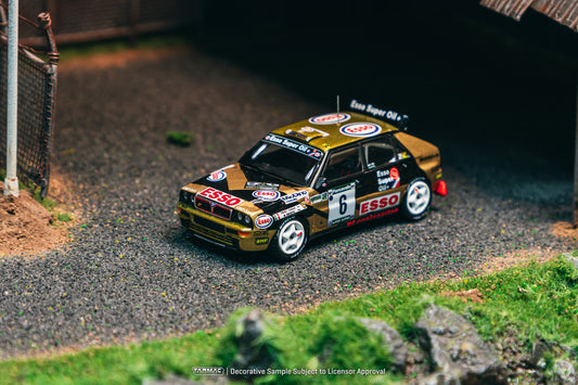 Tarmac Works 1:64 Lancia Delta HF Integrale #6 gold and black Piancavallo Rally winner 1993 model car. Front