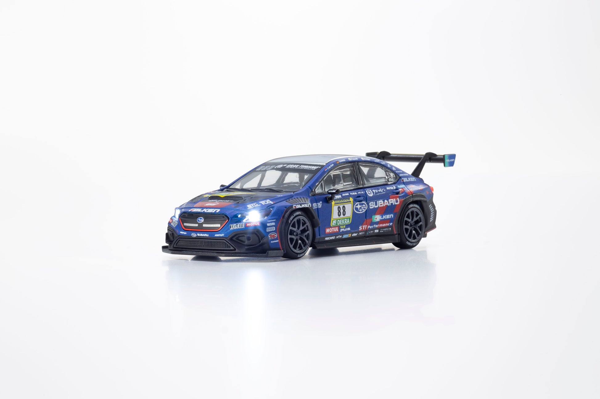 Kyosho 1:64 Subaru WRX STI NBR 2024 MOTN model with activated headlights and taillights.