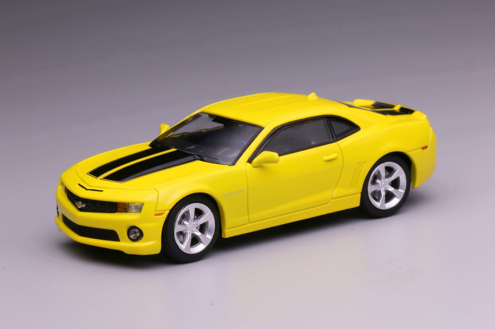 596 Models 2009 Chevrolet Camaro in yellow with black racing stripes.