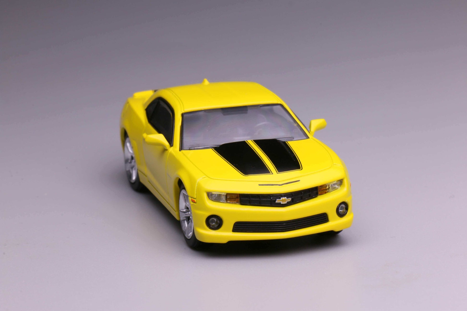 596 Models 2009 Chevrolet Camaro in yellow with black racing stripes. Front