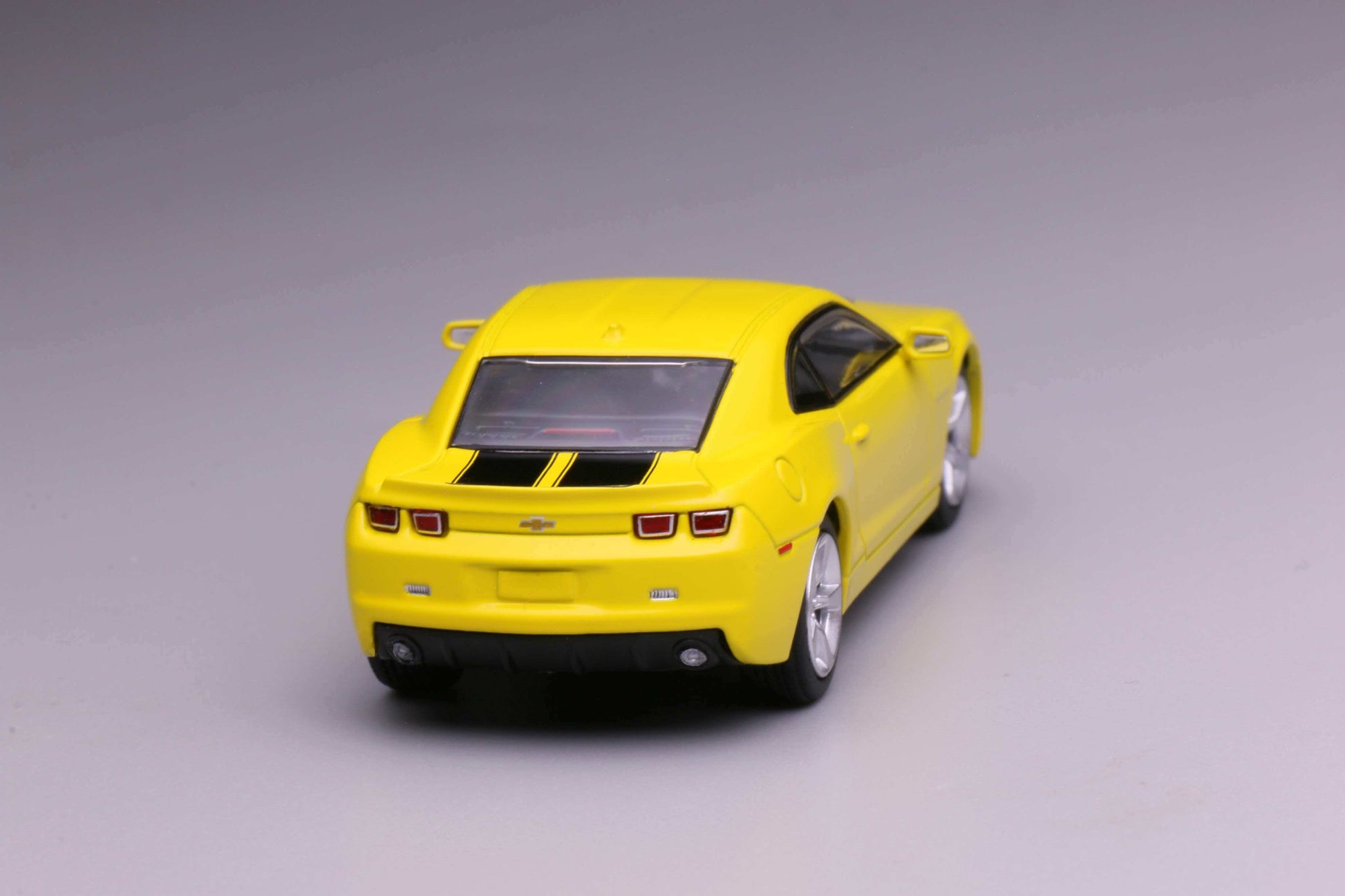 596 Models 2009 Chevrolet Camaro in yellow with black racing stripes. Back