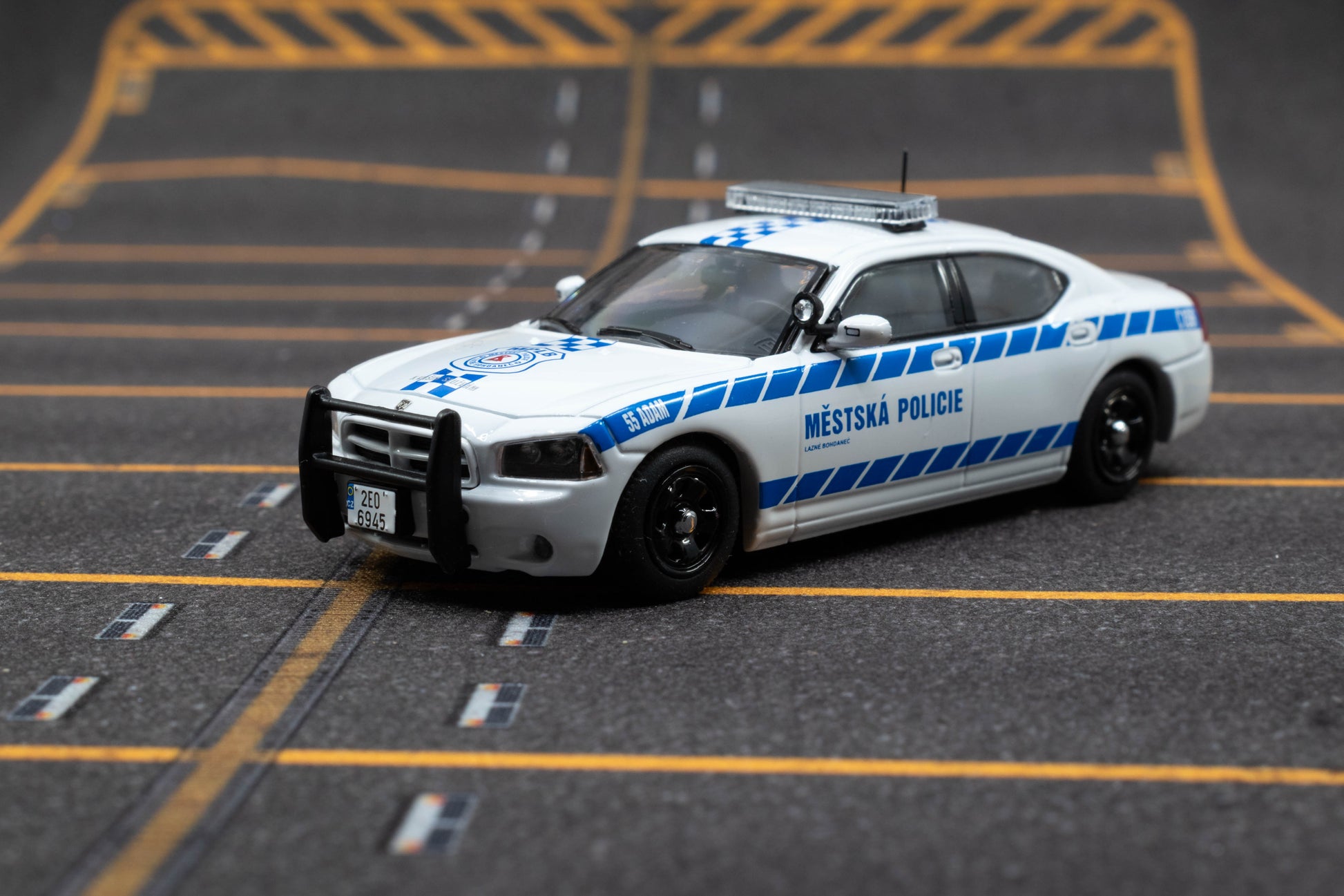 JR Collectibles x Rollin – Městská Policie Lázně Bohdaneč “Adam” 1:64 scale police car with blue-and-white livery.