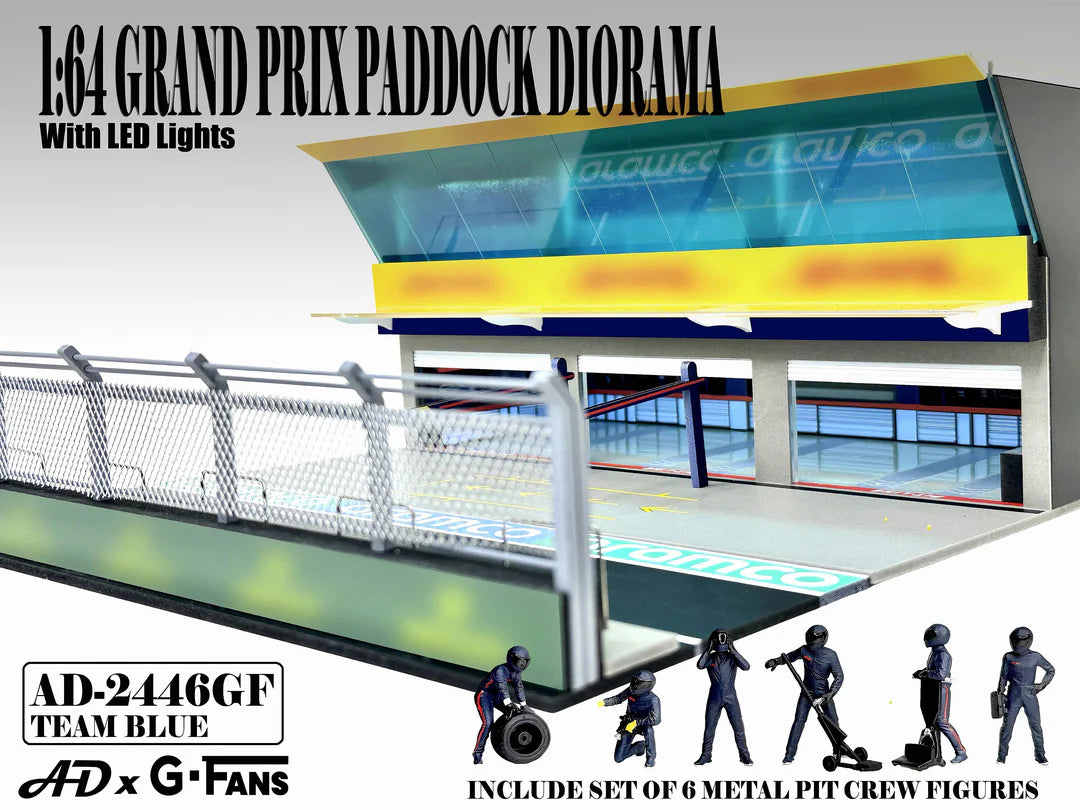 American Diorama Grand Prix Paddock Team Blue 1:64 diorama with LED lighting, metal debris fence, and six pit crew figures.