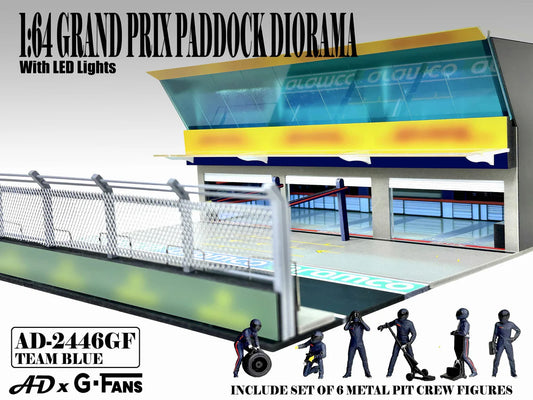 American Diorama Grand Prix Paddock Team Blue 1:64 diorama with LED lighting, metal debris fence, and six pit crew figures.