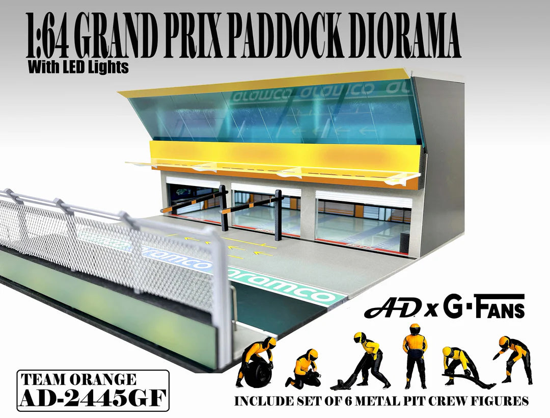 American Diorama Grand Prix Paddock Team Orange 1:64 diorama with LED lighting, metal debris fence, and six pit crew figures.