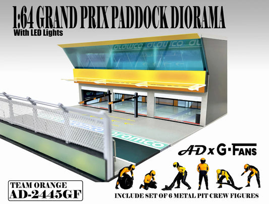 American Diorama Grand Prix Paddock Team Orange 1:64 diorama with LED lighting, metal debris fence, and six pit crew figures.