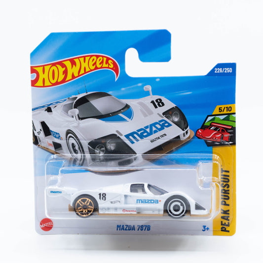 Hot Wheels Mazda 787B diecast car model in 1:64 scale with iconic orange-and-green racing livery and aerodynamic design