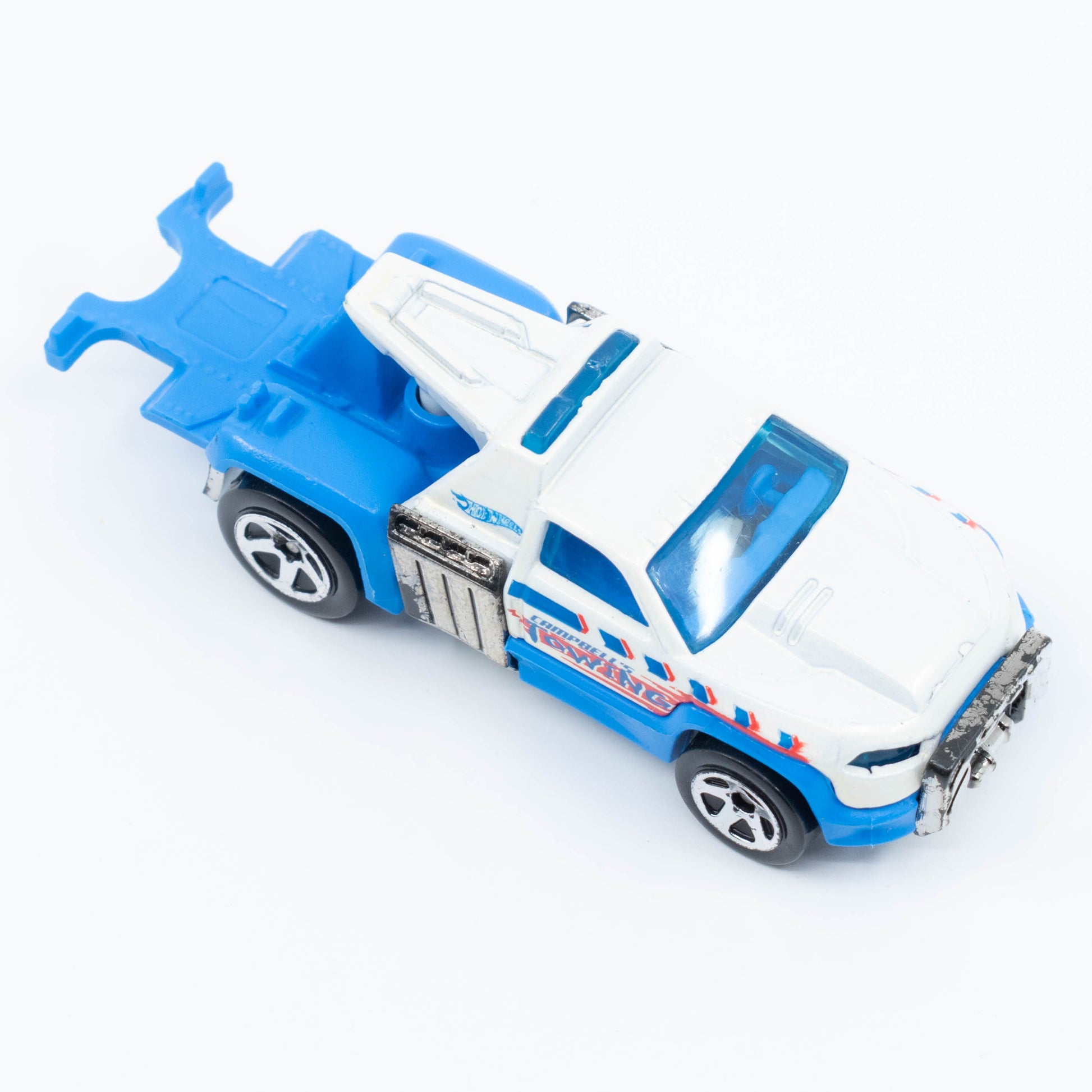Hot Wheels Repo Duty tow truck with hook and utility bed in 1:64 scale. Top