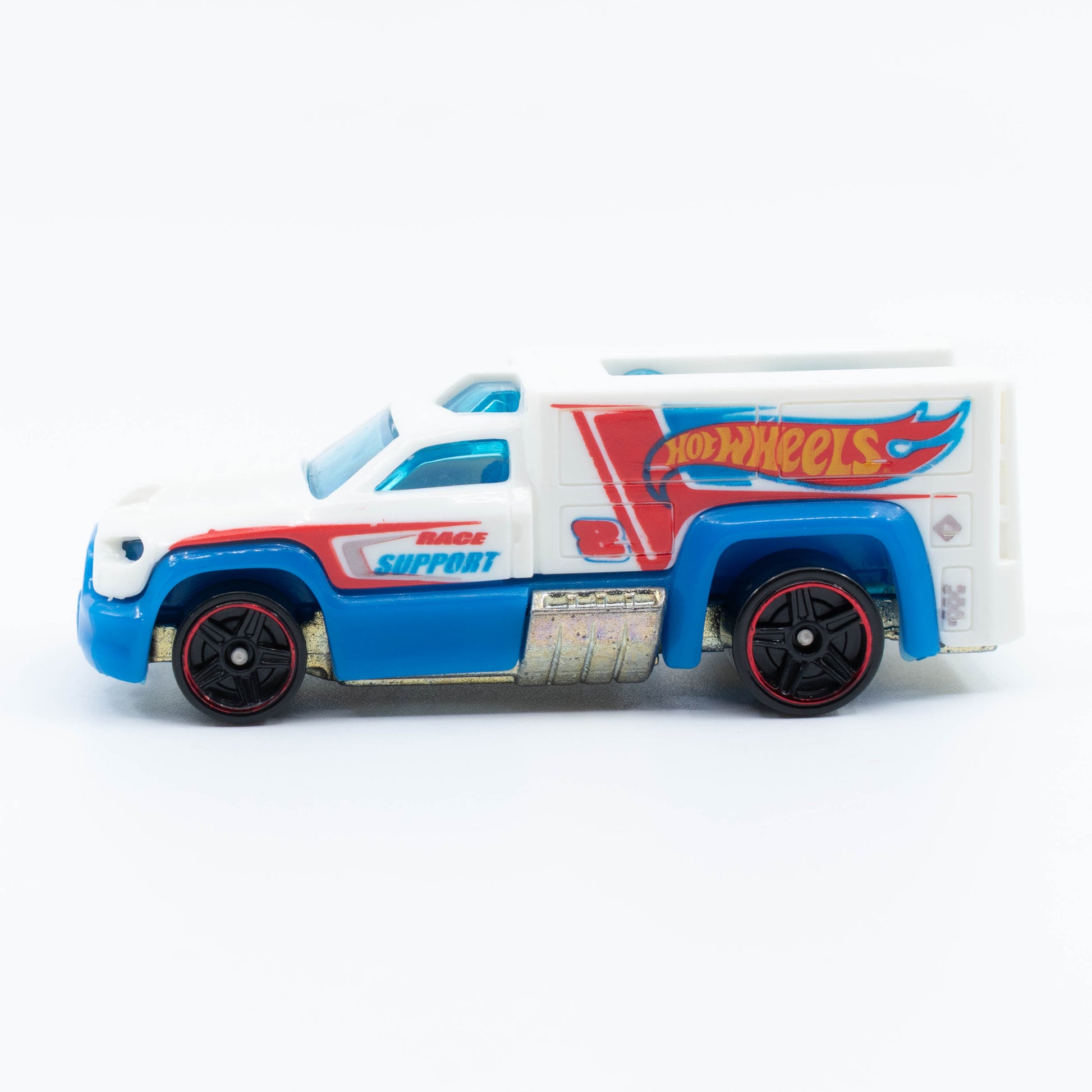 Hot Wheels Rescue Duty 1:64 scale emergency truck with light bar and white-and-blue rescue graphics. Side