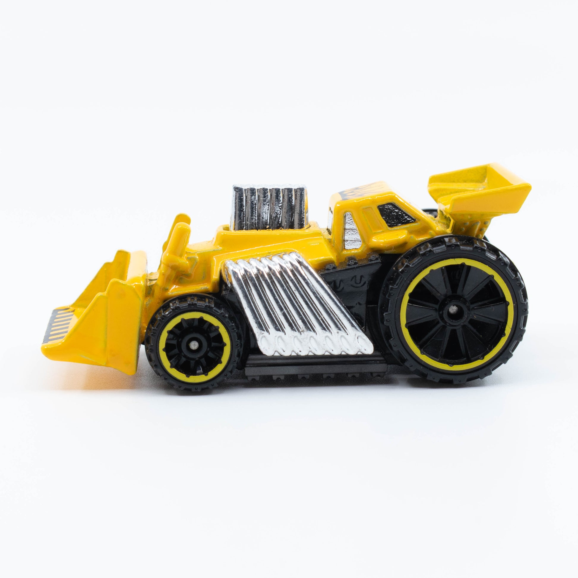 Hot Wheels Speed Dozer 1:64 diecast with front blade and heavy-duty wheels. Side