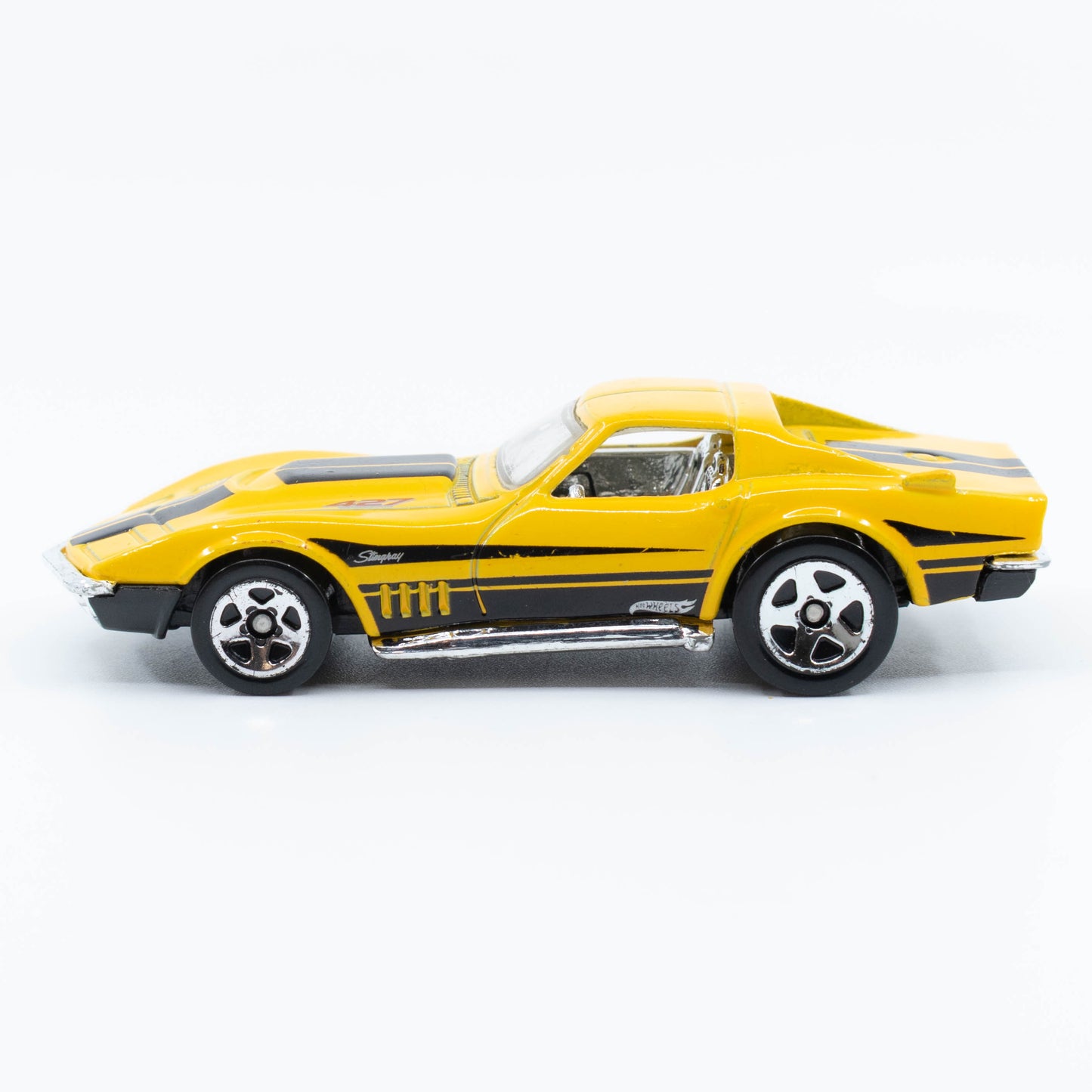 Hot Wheels 1:64 scale '69 Corvette diecast with classic muscle car design and detailed finish. Side