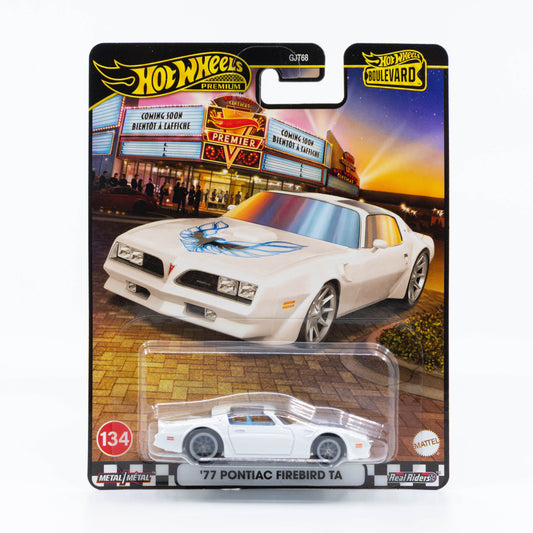 Hot Wheels Boulevard ’77 Pontiac Firebird Trans Am in white with blue accents, featuring the Firebird hood decal, real riders wheels, and detailed metal construction.