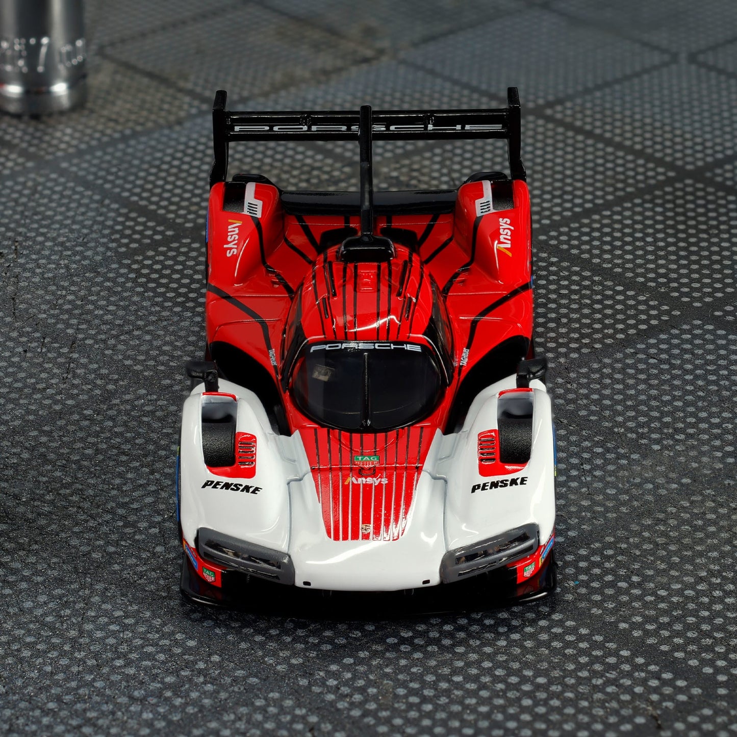 Hot Wheels Elite 64 Porsche 963 in Penske Team livery, featuring red, white, and black racing colors, detailed aero bodywork, and Real Riders wheels.