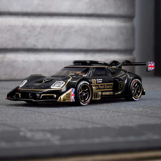Hot Wheels Elite 64 Radford Type 62-2 Pikes Peak in black and gold JPS livery, featuring aerodynamic bodywork, gold Real Riders wheels, and fine race detailing.