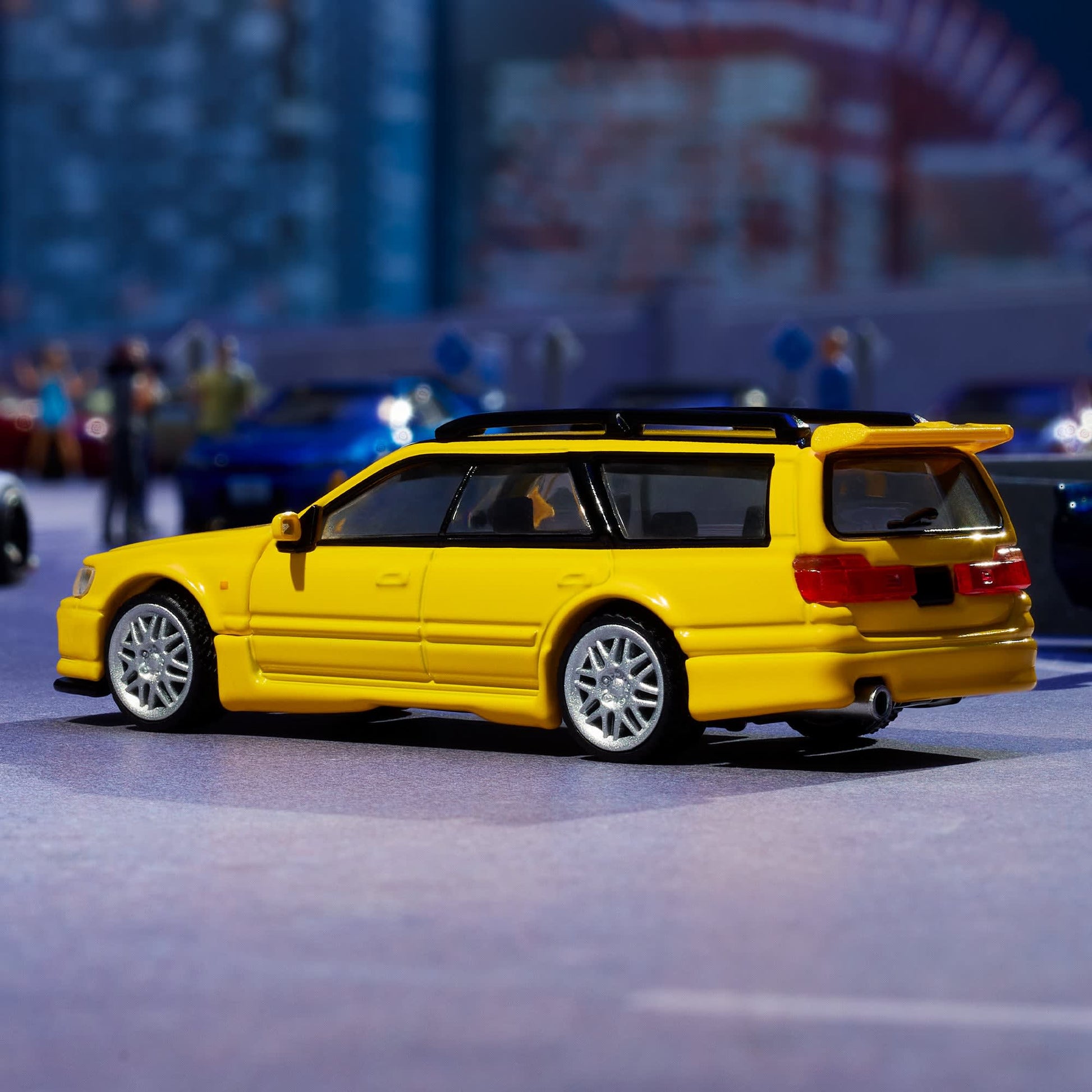 Hot Wheels Elite 64 Mod Shop Nissan Stagea in gloss yellow with interchangeable GT-R front end, opening hood, RB26 engine, and accessory kit.