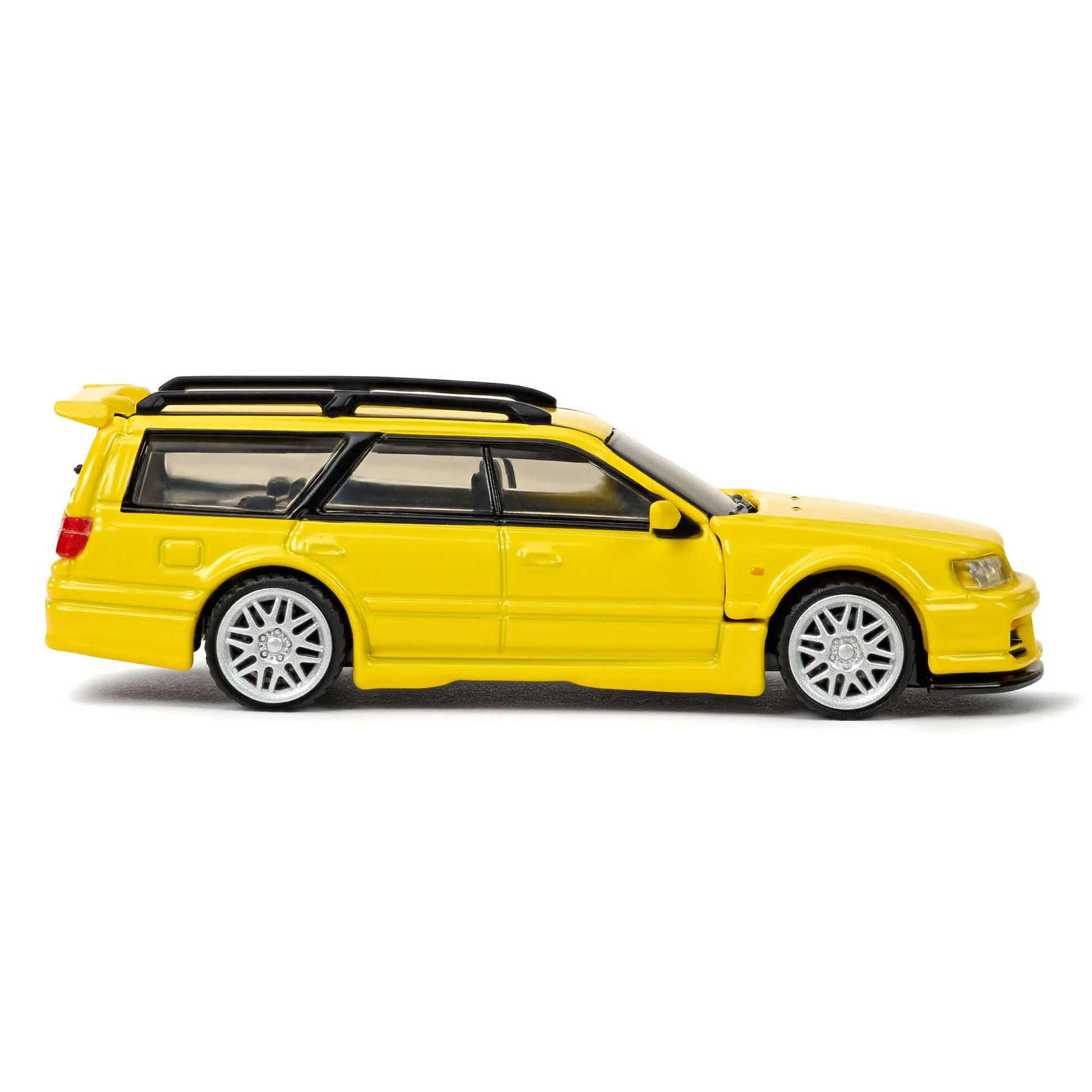 Hot Wheels Elite 64 Mod Shop Nissan Stagea in gloss yellow with interchangeable GT-R front end, opening hood, RB26 engine, and accessory kit.