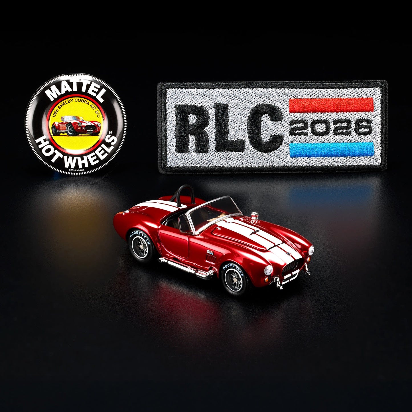 Hot Wheels RLC 2026 membership car, 1965 Shelby Cobra 427 S/C in Spectraflame bright red with opening hood and detailed V8 engine.