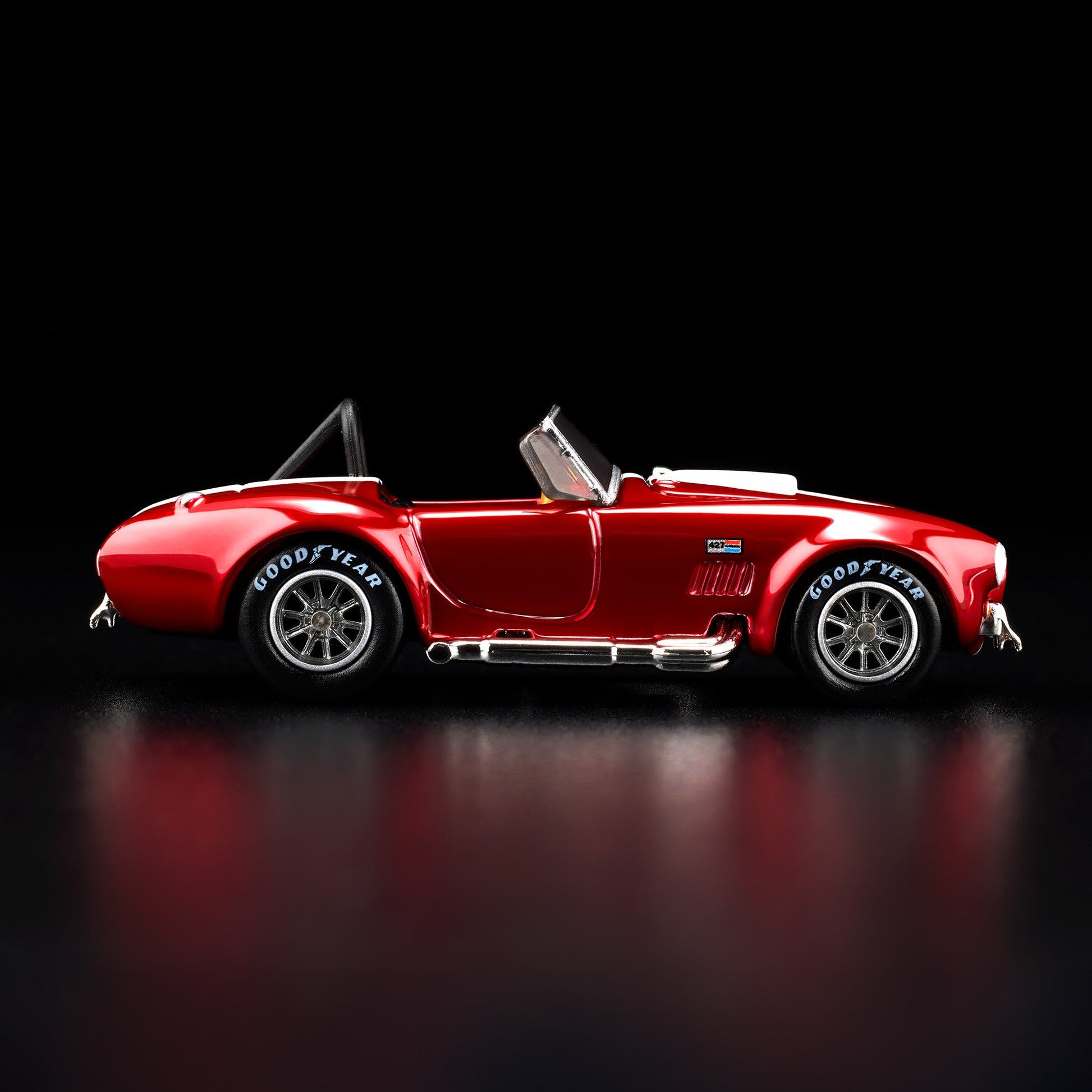 Hot Wheels RLC 2026 membership car, 1965 Shelby Cobra 427 S/C in Spectraflame bright red with opening hood and detailed V8 engine.