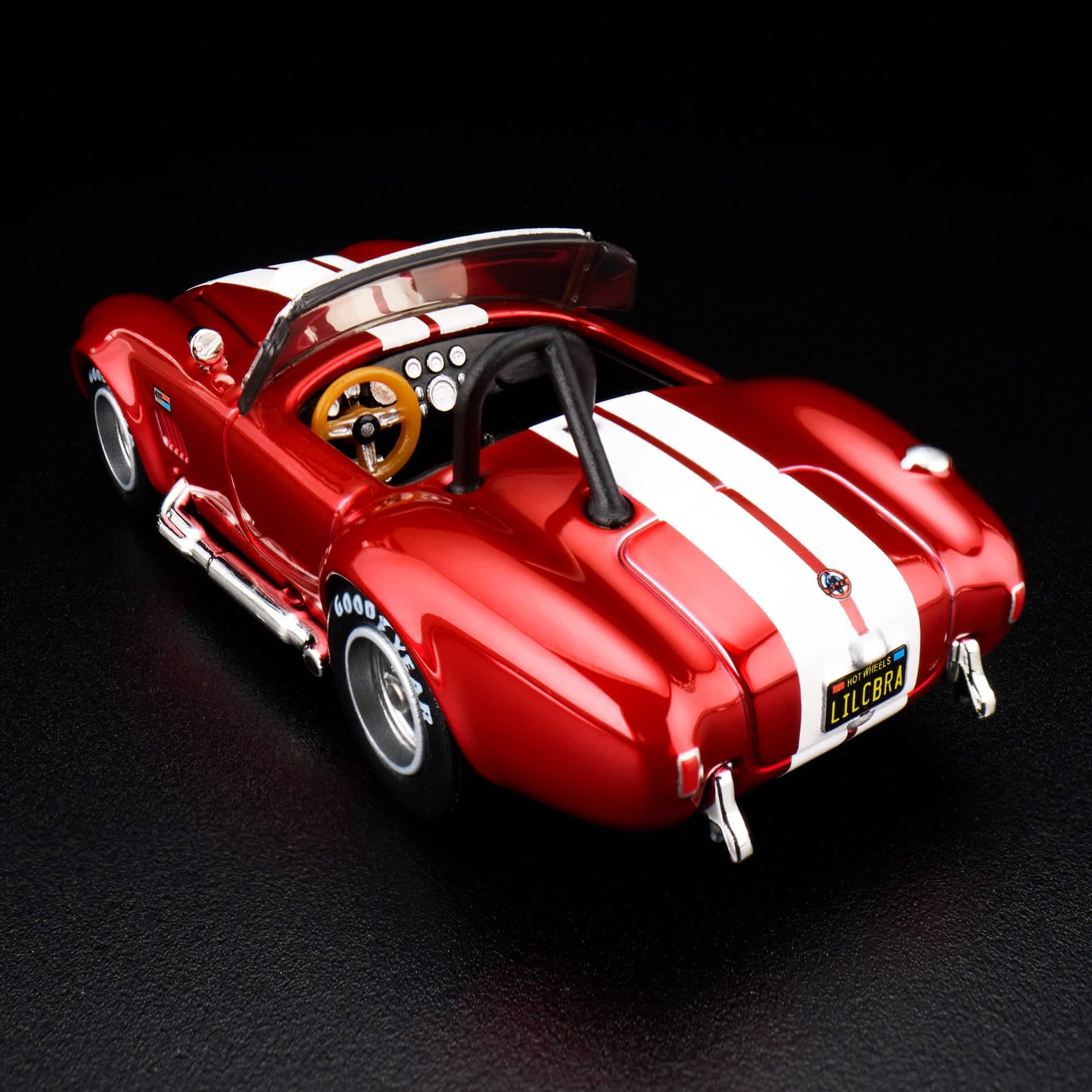 Hot Wheels RLC 2026 membership car, 1965 Shelby Cobra 427 S/C in Spectraflame bright red with opening hood and detailed V8 engine.