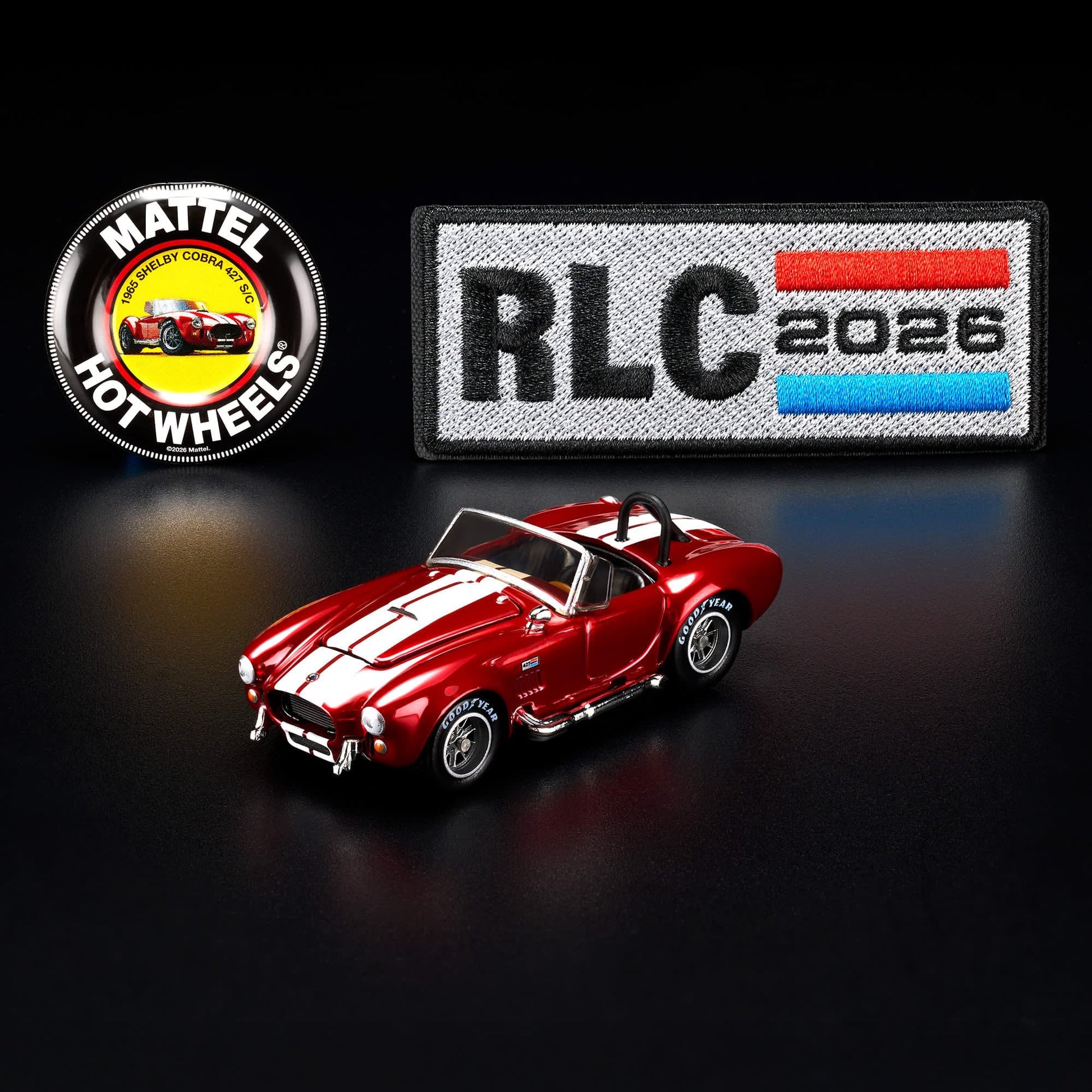 Hot Wheels RLC 2026 membership car, 1965 Shelby Cobra 427 S/C in Spectraflame bright red with opening hood and detailed V8 engine.