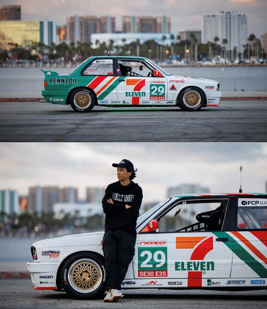 1:64 Kaido*House BMW M3 Larry Chen V1 in green and white 7-Eleven livery, featuring wide-body stance, racing decals, and custom aero details. Real car