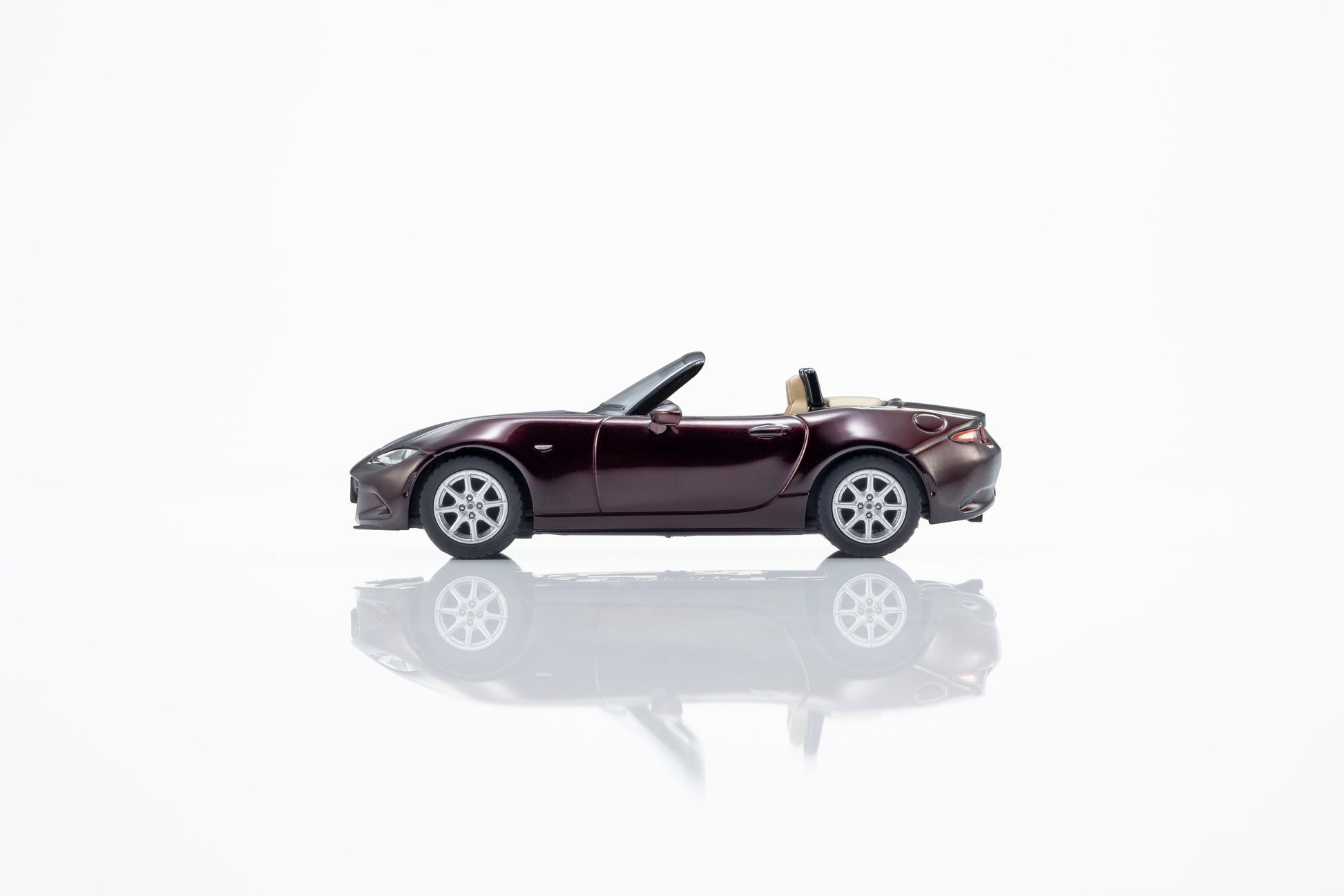 Kyosho 1:64 Mazda Roadster 35th Anniversary red convertible diecast model. Side
