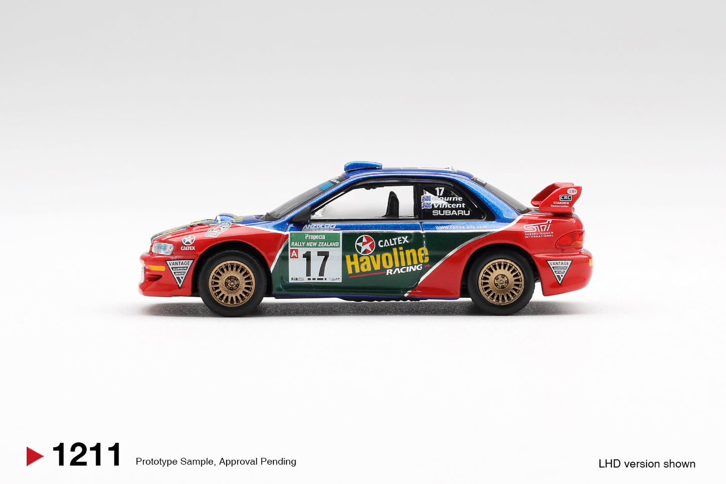 Mini GT 1:64 Subaru Impreza WRC98 #17 Rally New Zealand 2000 red blue rally diecast model. Side