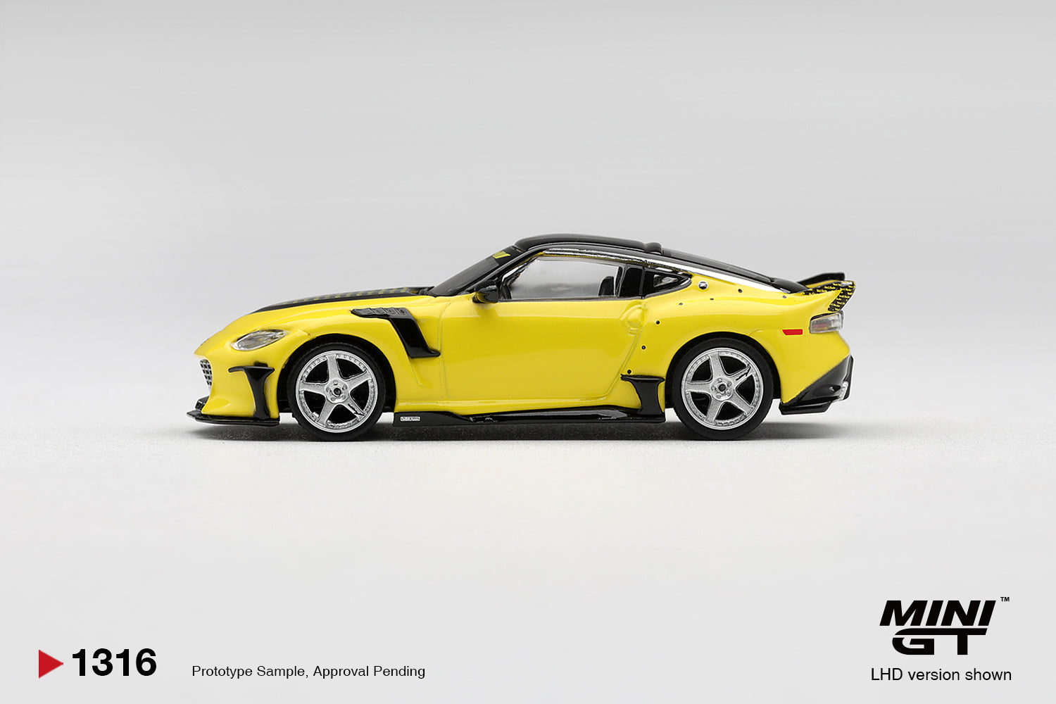Mini GT Nissan FFZ400 VeilSide in Ikazuchi Yellow with aggressive widebody styling. Side