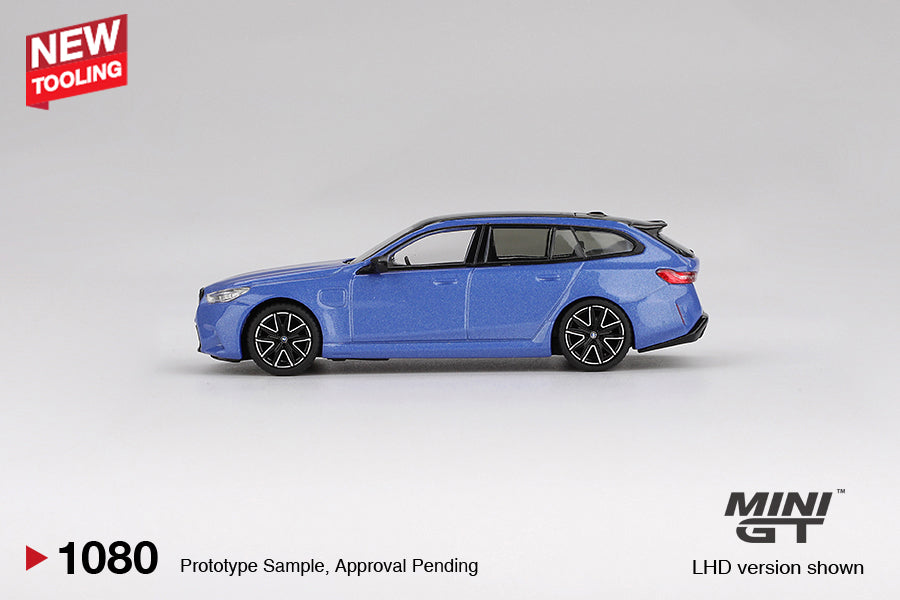 Mini GT BMW M5 (G99) Touring in metallic Marina Bay Blue, 1:64 scale diecast model. Side
