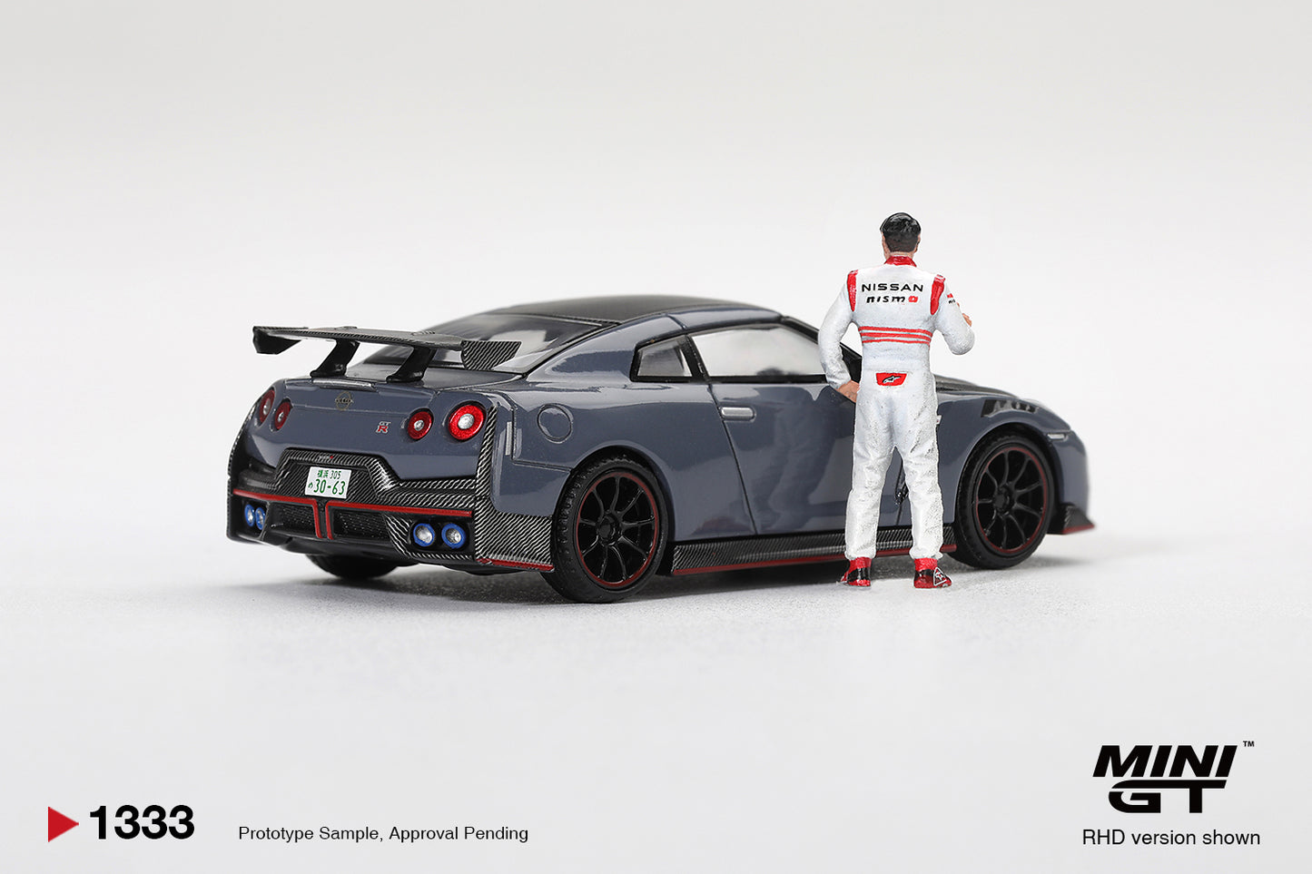 Mini GT Nissan GT-R R35 Nismo Tsukuba Lap Record with Tsugio Matsuda figure.