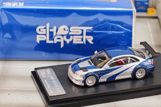 Street Weapon BMW M3 GTR diecast model inspired by Need for Speed: Most Wanted, featuring blue and silver livery, wide body kit, and rear wing in 1:64 scale.