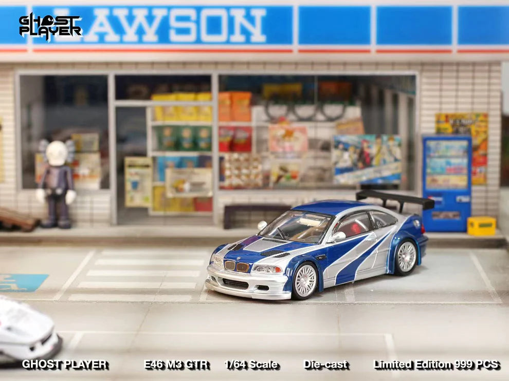 Street Weapon BMW M3 GTR diecast model inspired by Need for Speed: Most Wanted, featuring blue and silver livery, wide body kit, and rear wing in 1:64 scale.