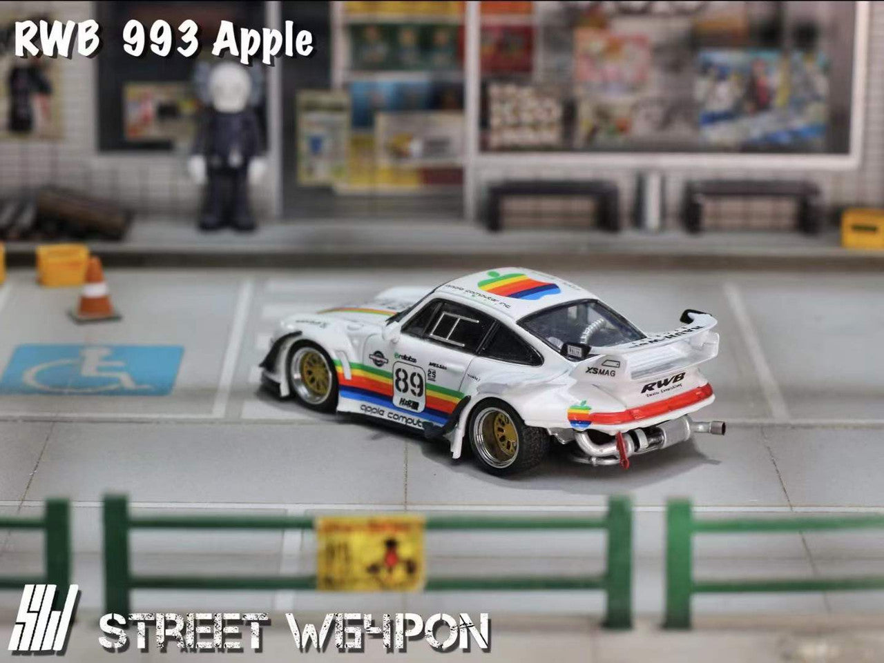 Street Weapon RWB 993 diecast in Apple Computer rainbow-striped livery, featuring widebody fenders, large rear wing, and detailed Porsche 993 design in 1:64 scale. Back