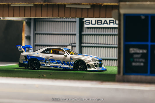 Tarmac Works Nissan Skyline GT-R ER34 LB Super Silhouette MGMini SEMA Show in silver and blue.