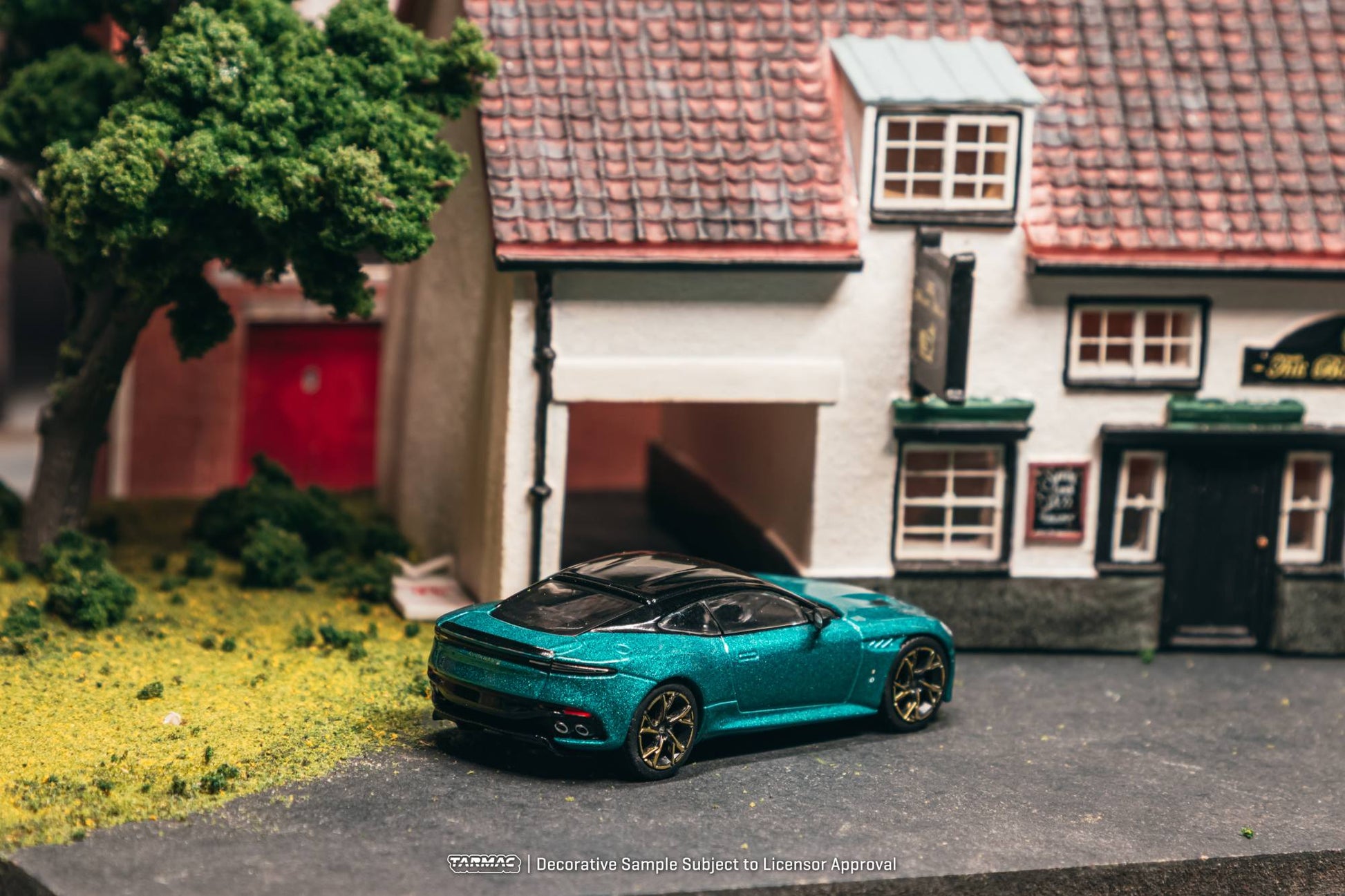 Tarmac Works 1:64 Aston Martin DBS Superleggera green metallic bronze accents diecast model. Back